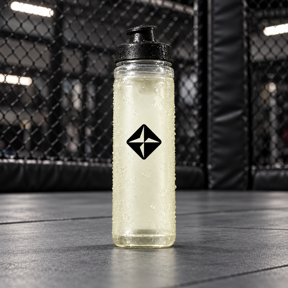 PYRATE bottle on an MMA mat beside cage fencing